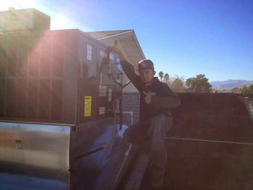 HVAC technician performing Boiler Repair on a rooftop unit in Vashon